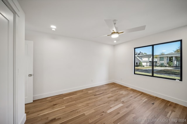 spare room with light hardwood / wood-style flooring and ceiling fan