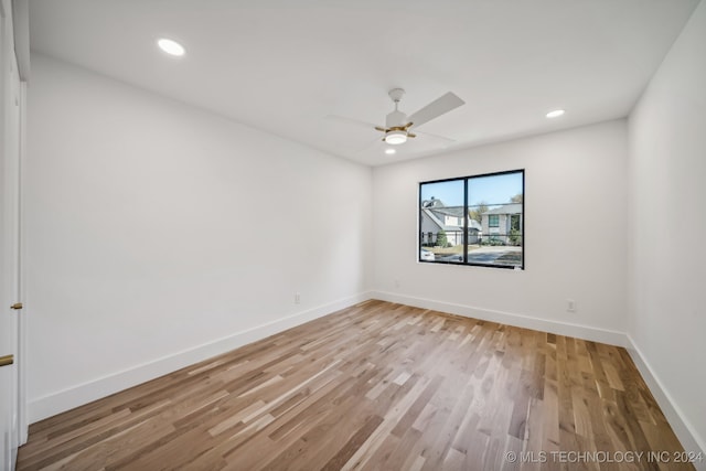 empty room featuring ceiling fan and light hardwood / wood-style floors