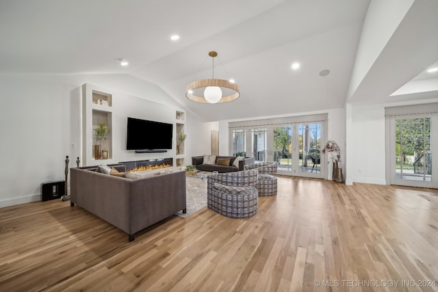 living room featuring french doors, light wood-type flooring, and lofted ceiling