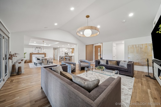 living room with vaulted ceiling and light hardwood / wood-style flooring