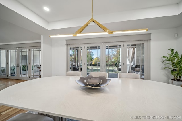 dining area with french doors and hardwood / wood-style flooring