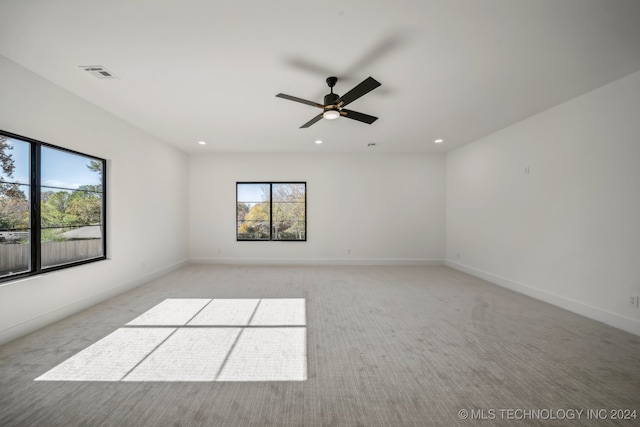 unfurnished room with ceiling fan and light colored carpet