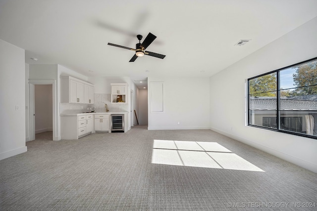 carpeted empty room with ceiling fan