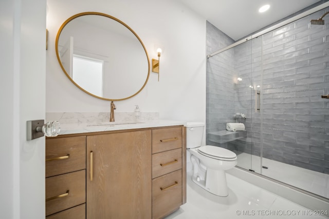 bathroom with tile patterned floors, vanity, toilet, and an enclosed shower