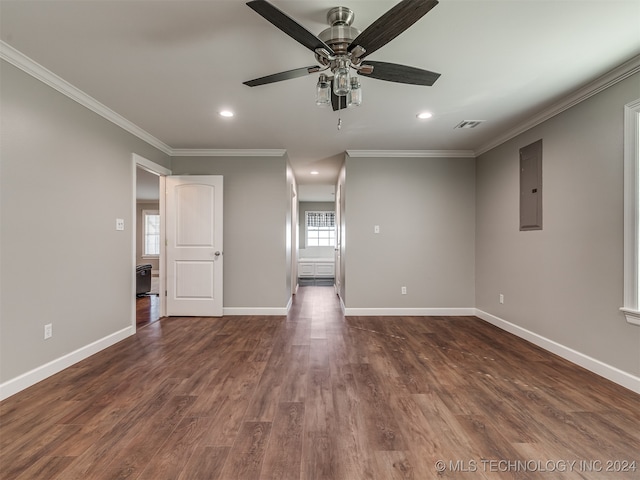 spare room with dark hardwood / wood-style flooring, electric panel, ceiling fan, and crown molding