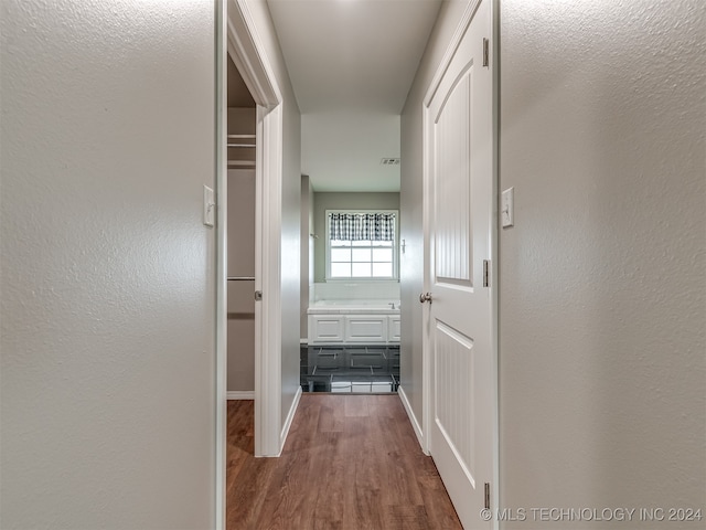 hall with hardwood / wood-style floors