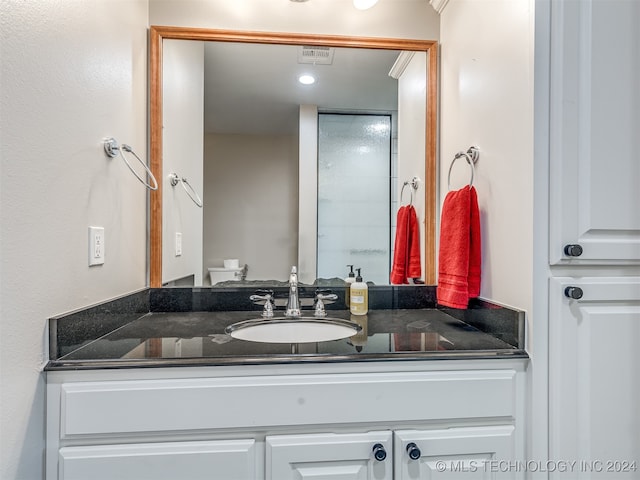 bathroom featuring vanity and toilet