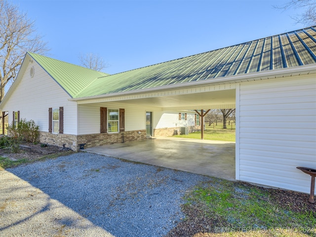 view of property exterior with a carport