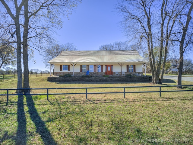 single story home featuring a rural view and a front lawn