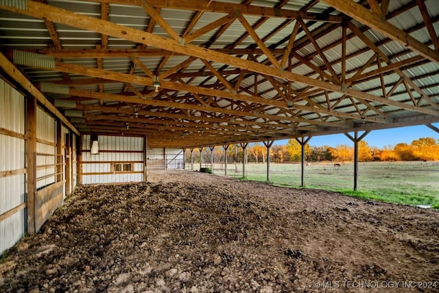 view of horse barn featuring a rural view