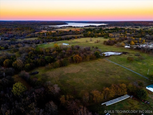 aerial view at dusk with a water view