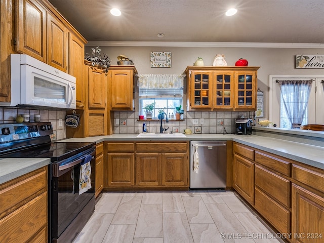 kitchen with decorative backsplash, stainless steel dishwasher, ornamental molding, sink, and black range with electric stovetop