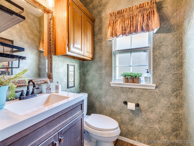 bathroom featuring vanity and toilet