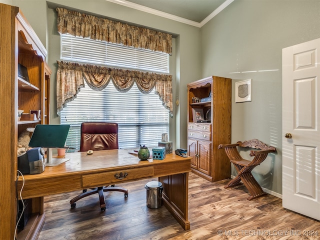 home office with wood-type flooring and ornamental molding