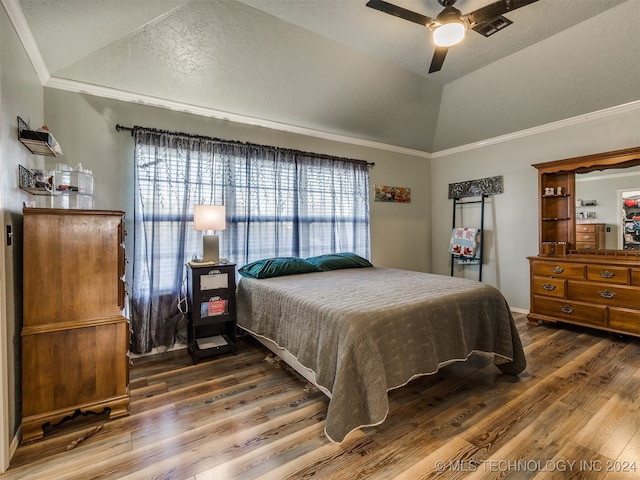 bedroom featuring hardwood / wood-style flooring, crown molding, ceiling fan, and lofted ceiling