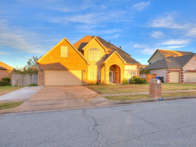 view of property with a garage and a front yard