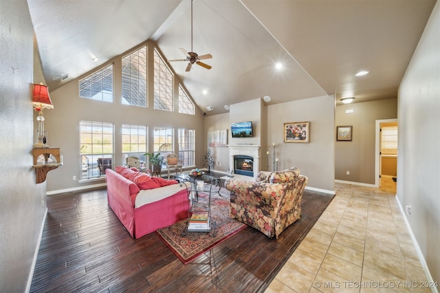 living room with hardwood / wood-style flooring, ceiling fan, beam ceiling, and high vaulted ceiling