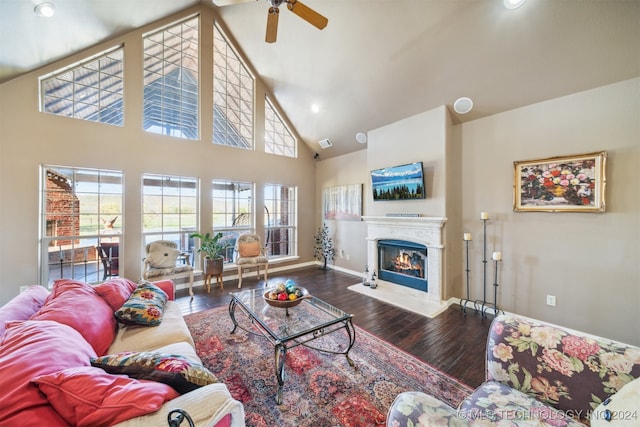 living room featuring dark hardwood / wood-style flooring, high vaulted ceiling, and ceiling fan