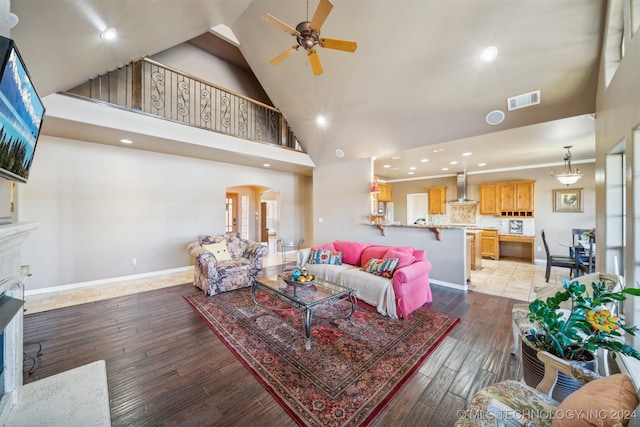 living room with hardwood / wood-style floors, high vaulted ceiling, and ceiling fan