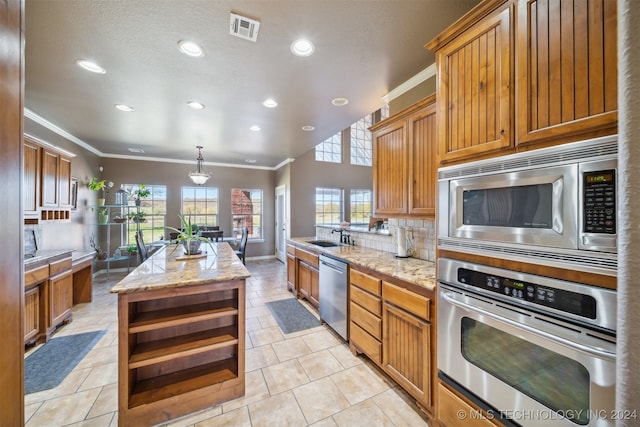 kitchen featuring a center island, tasteful backsplash, crown molding, decorative light fixtures, and appliances with stainless steel finishes