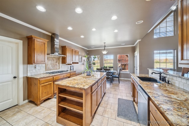 kitchen with a kitchen island with sink, wall chimney exhaust hood, a healthy amount of sunlight, and appliances with stainless steel finishes