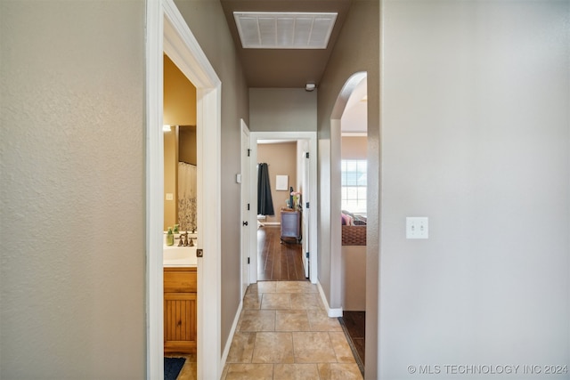 hallway featuring light tile patterned flooring