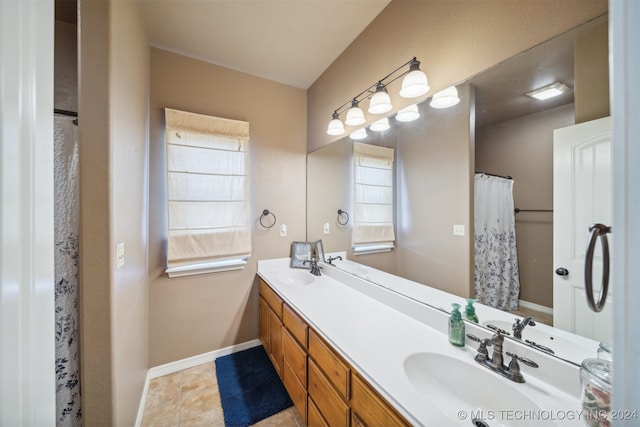 bathroom with tile patterned flooring and vanity