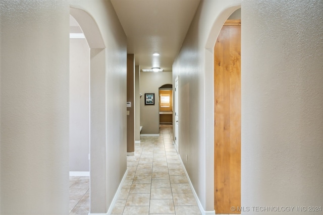 hallway featuring light tile patterned floors