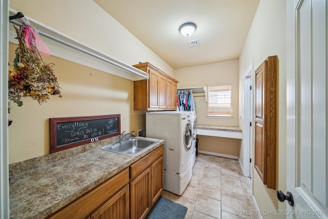 washroom featuring cabinets, independent washer and dryer, sink, and light tile patterned floors