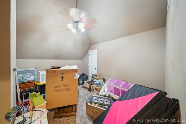 interior space featuring carpet flooring, ceiling fan, and vaulted ceiling