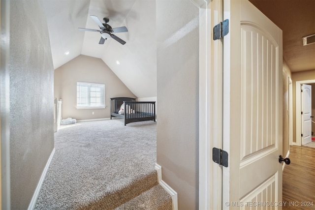 interior space with carpet, ceiling fan, and vaulted ceiling