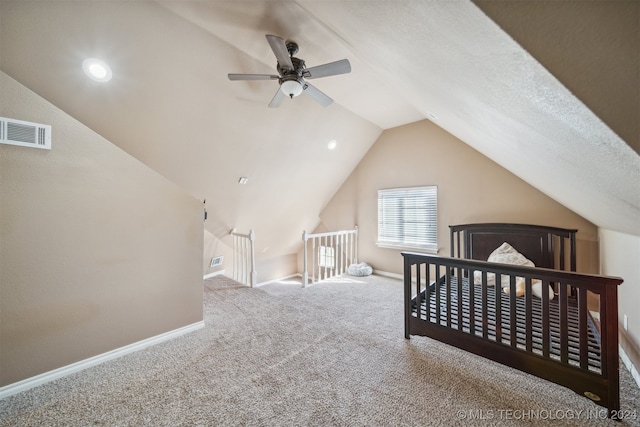 bedroom featuring carpet, a textured ceiling, vaulted ceiling, and ceiling fan