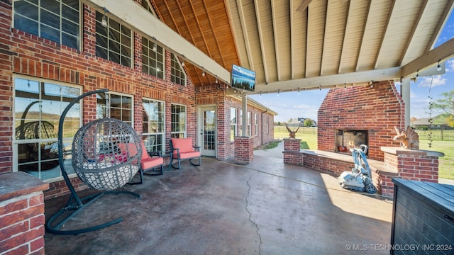 view of patio / terrace with an outdoor brick fireplace