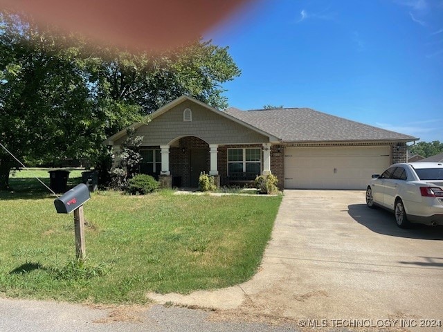 view of front of house featuring a front yard and a garage