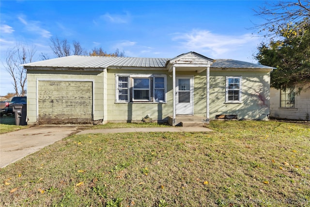 view of front of house with a garage and a front lawn