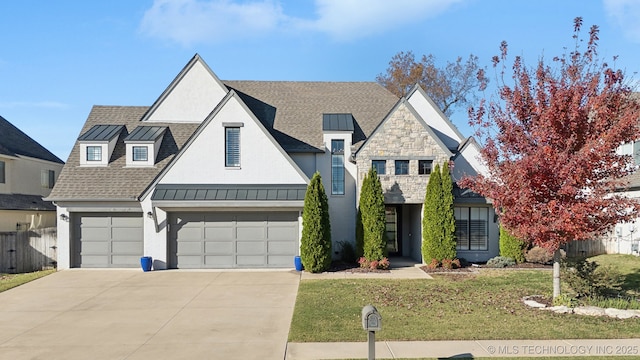 view of front of property with a garage and a front lawn