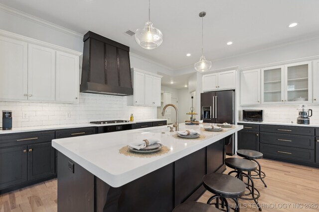 dining space with crown molding and light hardwood / wood-style flooring