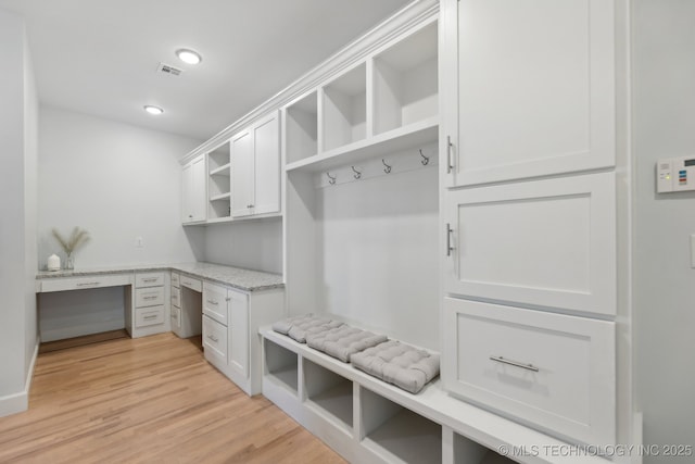 mudroom with light wood-type flooring and built in desk