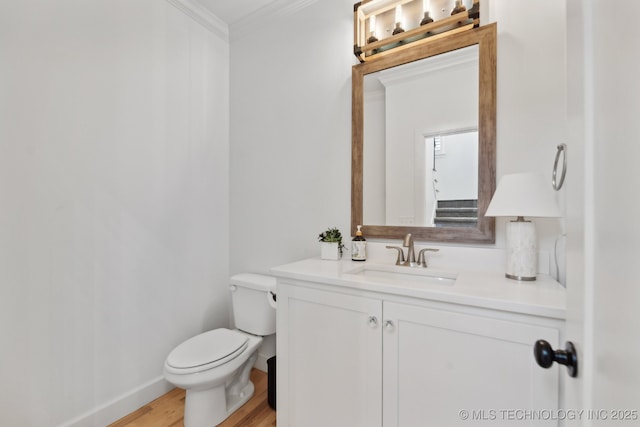 bathroom featuring hardwood / wood-style floors, vanity, toilet, and ornamental molding