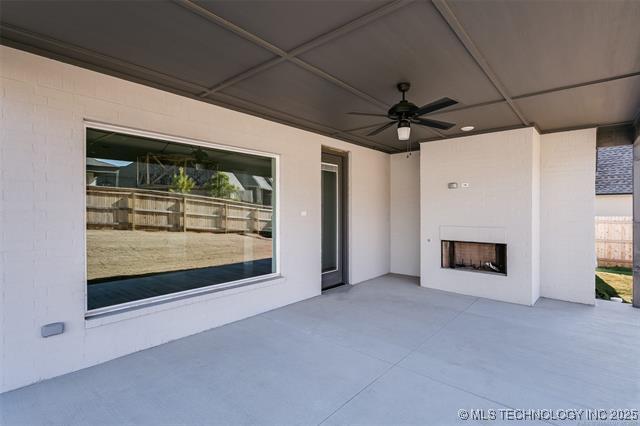 back of house featuring a lawn, cooling unit, a patio area, and a fireplace