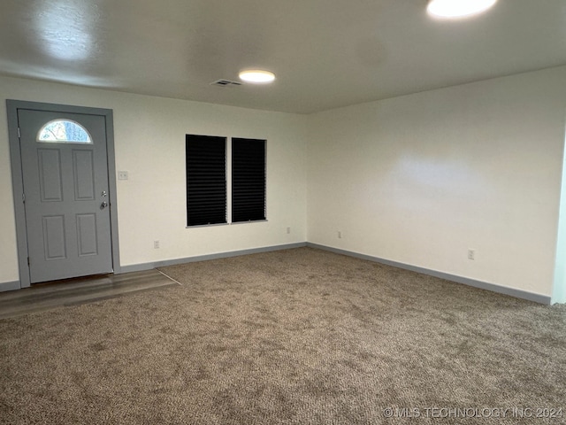 view of carpeted foyer entrance