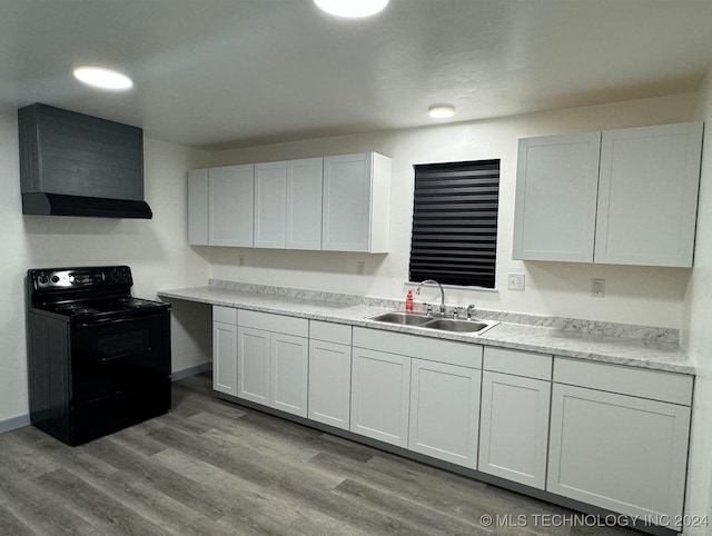 kitchen with light hardwood / wood-style floors, white cabinetry, sink, and black / electric stove