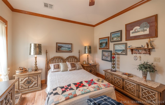 bedroom with light wood-type flooring, ceiling fan, and crown molding