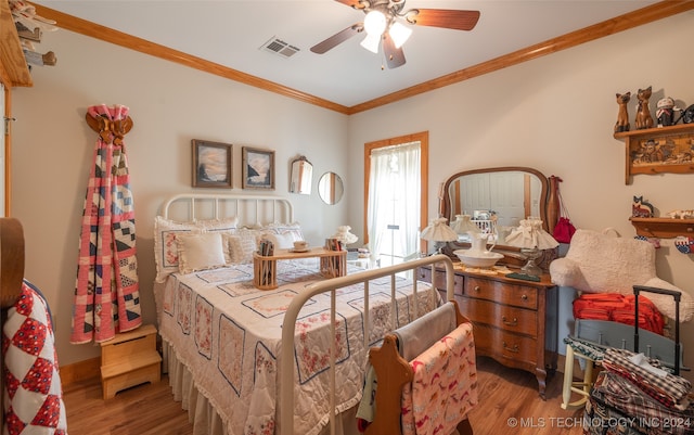 bedroom featuring ceiling fan, hardwood / wood-style floors, and ornamental molding