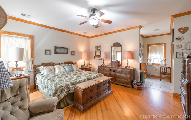 bedroom with ceiling fan, crown molding, and light hardwood / wood-style flooring