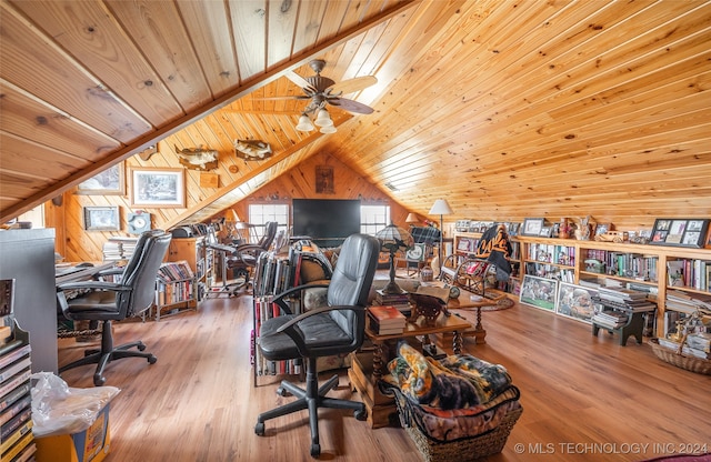 home office with wood-type flooring, vaulted ceiling, wood ceiling, and wood walls