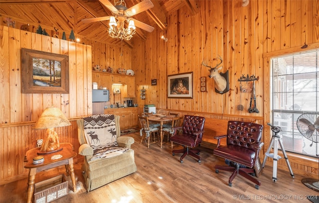 sitting room featuring beam ceiling, ceiling fan, wooden ceiling, wood walls, and hardwood / wood-style floors