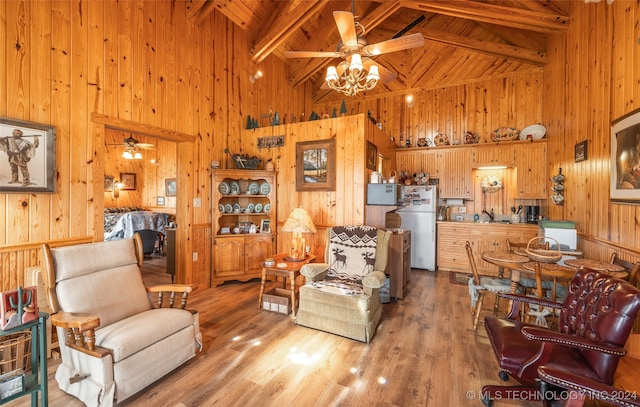 living room featuring beam ceiling, high vaulted ceiling, light hardwood / wood-style flooring, and ceiling fan