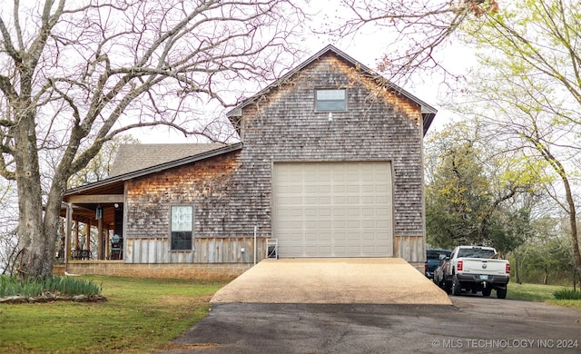 view of front of property with a front lawn and a garage