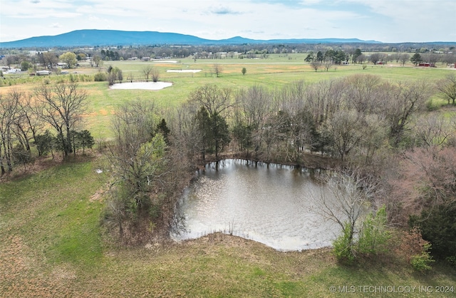 drone / aerial view featuring a rural view and a water and mountain view